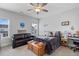 Spacious bedroom featuring a dark sofa, ceiling fan and neutral colors at 1530 Armscroft Ln, Apex, NC 27502