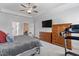 Large primary bedroom with a treadmill, ample closet space, and a decorative tray ceiling at 1530 Armscroft Ln, Apex, NC 27502