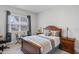 Tranquil bedroom featuring a wood-framed bed, soft textiles, and a cozy window nook at 1530 Armscroft Ln, Apex, NC 27502