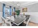 Bright dining room featuring a stylish table with seating for eight, and large window at 1530 Armscroft Ln, Apex, NC 27502