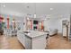 Open-concept kitchen featuring a large island and stainless steel appliances at 1530 Armscroft Ln, Apex, NC 27502