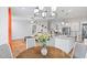 Open concept living area with a dining table and stylish decor flowing into the living room at 1530 Armscroft Ln, Apex, NC 27502