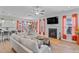 Open concept living area featuring fireplace, dining space, and modern kitchen in the background at 1530 Armscroft Ln, Apex, NC 27502