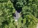 Aerial view of home's roof surrounded by mature trees at 1706 Us Hwy 70A E, Hillsborough, NC 27278