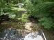 Lush backyard with mature trees and shed at 1706 Us Hwy 70A E, Hillsborough, NC 27278