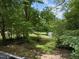 Lush, green backyard with mature trees at 1706 Us Hwy 70A E, Hillsborough, NC 27278