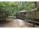 Backyard exterior of the home with white siding and a gray deck with stairs at 1706 Us Hwy 70A E, Hillsborough, NC 27278