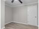 Bedroom features neutral paint, contemporary flooring, ceiling fan and a standard door at 1706 Us Hwy 70A E, Hillsborough, NC 27278