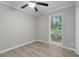 A cozy bedroom featuring a ceiling fan, wood-look floors, and a window providing natural light at 1706 Us Hwy 70A E, Hillsborough, NC 27278