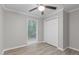 Bedroom featuring a window with wooded views, a ceiling fan, and a closet for storage at 1706 Us Hwy 70A E, Hillsborough, NC 27278