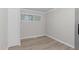 Bright bedroom featuring neutral paint, modern flooring, a window, and a closet at 1706 Us Hwy 70A E, Hillsborough, NC 27278