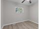 A bright bedroom with a ceiling fan, wood-look floors, and a window offering pleasant natural light at 1706 Us Hwy 70A E, Hillsborough, NC 27278