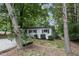 Charming single-story home featuring mature trees and landscaping at 1706 Us Hwy 70A E, Hillsborough, NC 27278