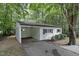 Exterior of house including covered carport with a tree providing shade on a sunny day at 1706 Us Hwy 70A E, Hillsborough, NC 27278