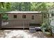 Exterior of the home with a white door and siding with a gray wooden porch at 1706 Us Hwy 70A E, Hillsborough, NC 27278