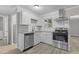 Modern kitchen features stainless steel appliances, granite counters, white cabinets, and a subway tile backsplash at 1706 Us Hwy 70A E, Hillsborough, NC 27278
