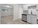 Modern kitchen features stainless steel appliances, granite counters, white cabinets, and a subway tile backsplash at 1706 Us Hwy 70A E, Hillsborough, NC 27278