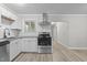Modern kitchen features stainless steel appliances, granite counters, white cabinets, and a subway tile backsplash at 1706 Us Hwy 70A E, Hillsborough, NC 27278
