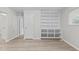 A spacious living room with wood-look floors and built-in shelves for ample storage and display space at 1706 Us Hwy 70A E, Hillsborough, NC 27278