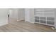 A bright living room boasts wood-look floors and built-in shelves for storage and a clean, modern look at 1706 Us Hwy 70A E, Hillsborough, NC 27278