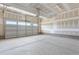 An empty, unfinished garage with a working automatic garage door at 1785 Birdhaven Ln, Wendell, NC 27591