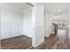 Bright hallway with elegant trim, hardwood flooring, and an open doorway leading to an adjacent room at 1785 Birdhaven Ln, Wendell, NC 27591