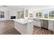 Kitchen island features stainless sink, dishwasher, and breakfast bar overlooking fireplace at 1785 Birdhaven Ln, Wendell, NC 27591