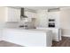 This kitchen is designed with white shaker cabinetry, stainless appliances, and a large island at 1785 Birdhaven Ln, Wendell, NC 27591