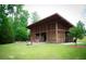 Lawn with a picnic pavilion, pink Adirondack chairs, bean bag toss and nice landscaping at 1785 Birdhaven Ln, Wendell, NC 27591