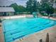 Community swimming pool with lap lanes, slide, lifeguard station, and lounge chairs at 1785 Birdhaven Ln, Wendell, NC 27591