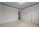 Clean bedroom with sliding closet doors, carpet, and view to another room via open door at 1837 Shamrock Dr, Burlington, NC 27215
