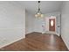 Traditional dining room with hardwood floors, decorative wallpaper, and an ornate chandelier fixture at 1837 Shamrock Dr, Burlington, NC 27215