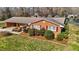 Attractive brick home showcasing neat landscaping with mulch beds and evergreen shrubs for added character at 1837 Shamrock Dr, Burlington, NC 27215