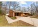 Brick home with convenient carport and landscaped entryway offering a blend of functionality and aesthetic appeal at 1837 Shamrock Dr, Burlington, NC 27215