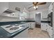 Functional kitchen design with white cabinets, ample counter space, and a stylish range hood, perfect for cooking at 1837 Shamrock Dr, Burlington, NC 27215