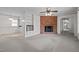 Open-concept living room with cozy brick fireplace, built-in display shelves, and seamless flow to the adjacent kitchen at 1837 Shamrock Dr, Burlington, NC 27215