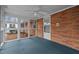 Relaxing sunroom featuring brick walls, lots of light, and neutral carpeting at 1837 Shamrock Dr, Burlington, NC 27215