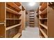 Large, wooden walk-in closet with ample shelving for storage at 1837 Shamrock Dr, Burlington, NC 27215