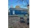 The home has light blue siding, a small deck, and a simple backyard with chairs at 206 Justice Heights St, Apex, NC 27502