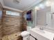 Modern bathroom features an updated vanity, pebble-stone shower and wood plank tile at 206 Justice Heights St, Apex, NC 27502