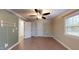 The bedroom has wood-look floors, neutral and green walls, a ceiling fan, and a window at 206 Justice Heights St, Apex, NC 27502