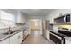 Modern kitchen boasts white cabinets, stainless steel appliances and tile backsplash at 206 Justice Heights St, Apex, NC 27502