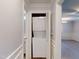 Hallway laundry closet featuring a stacked washer and dryer unit in a neutral color scheme at 206 Justice Heights St, Apex, NC 27502