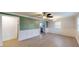 Open living room with a ceiling fan, hardwood floors, and white chair rail molding at 206 Justice Heights St, Apex, NC 27502