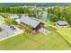 Aerial view showcasing community amenities including a lake, clubhouse, lawn area, and parking at 2335 Whitewing Ln, Wendell, NC 27591
