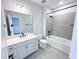 Clean bathroom with tiled shower-tub combo, spacious mirror, and white vanity at 2335 Whitewing Ln, Wendell, NC 27591