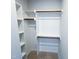 Spacious walk-in closet offering plenty of storage with wooden hanging rods and shelving at 2335 Whitewing Ln, Wendell, NC 27591