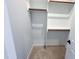 Walk-in closet with wooden rods and shelves at 2335 Whitewing Ln, Wendell, NC 27591