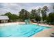 Resort-style community pool featuring lap lanes, zero entry, a splash zone, and a waterslide at 2335 Whitewing Ln, Wendell, NC 27591