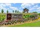 The Farmhouse community sign amidst colorful landscaping directs to model homes and community info at 2335 Whitewing Ln, Wendell, NC 27591